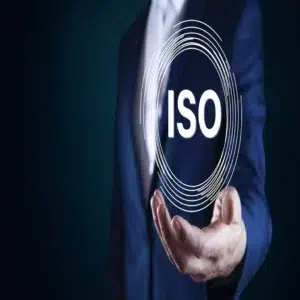 A businessman holding a glowing ISO symbol