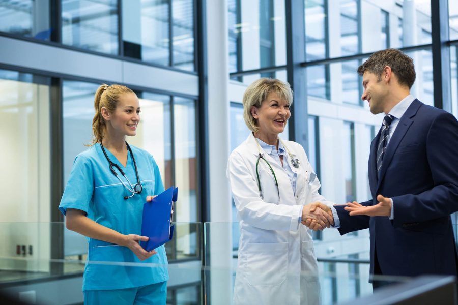 healthcare-management-professional-greets-doctor-nurse-cmprs
